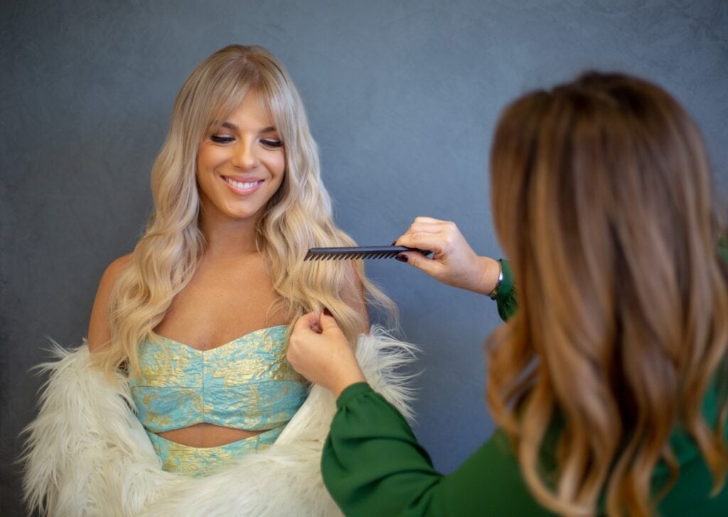lady combing another lady's hair﻿