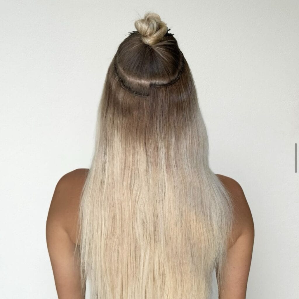 Seamless Hair Extensions Explained, Seamless Hair Extensions, Sew-In Weft Extension, Innovative Hair Extension Method, Lightweight Sew-In Extensions, Undetectable Hair Extensions, Sulphate-Free Shampoo, Conditioning Seamless Hair Extensions, Preventing Knots in Hair Extensions, Dyeing Human Hair Extensions, Toning and Bleaching Hair Extensions, Yovanka Loria Extensions, Styling Tips for Hair Extensions, Ceramic Heating Tools, Heat Protectant Spray, Longevity of Seamless Hair Extensions, Yovanka Loria Seamless Hair Extensions, Hair Extension Lifespan, Investment in Quality Hair, Consultation Appointment for Hair Extensions, Yovanka Loria Styling Recommendations, Easy Care for Seamless Extensions, Game-Changer in Hair Extensions, Endless Possibilities with Yovanka Loria Extensions, Yovanka Loria Client Experience, Yovanka Loria Consultation Booking